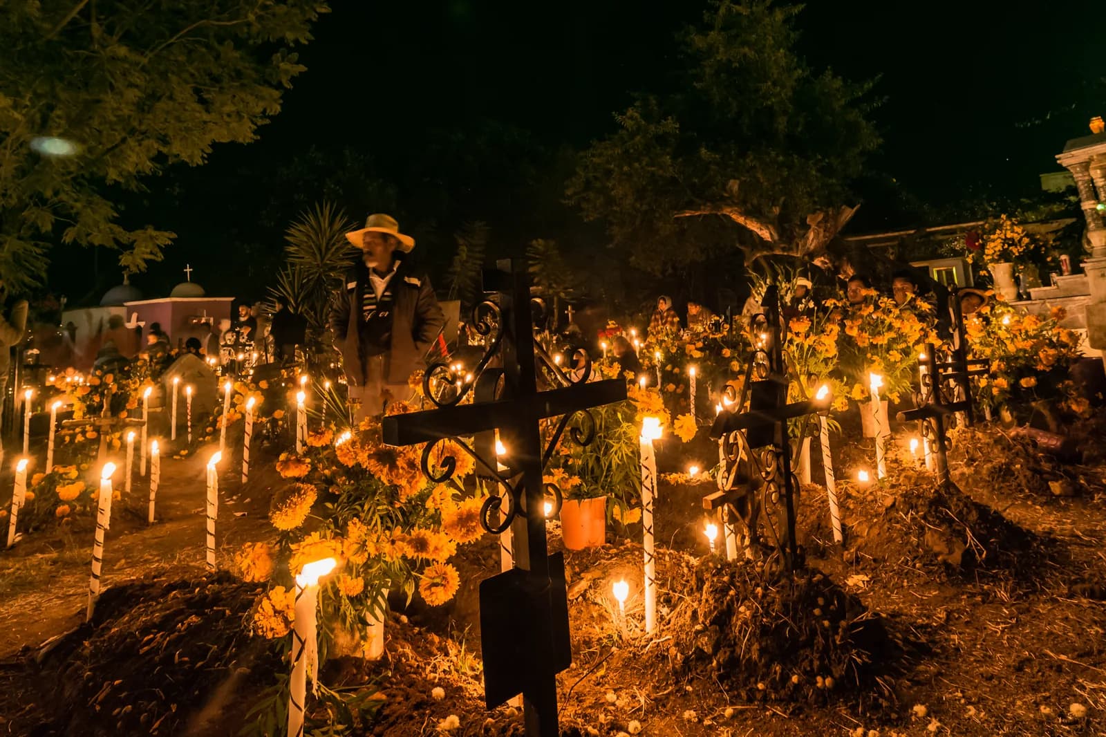 Veillée nocturne du Día de Muertos au cimetière de Santa María Atzompa près d'Oaxaca, tombes couvertes de bougies et de cempasúchil