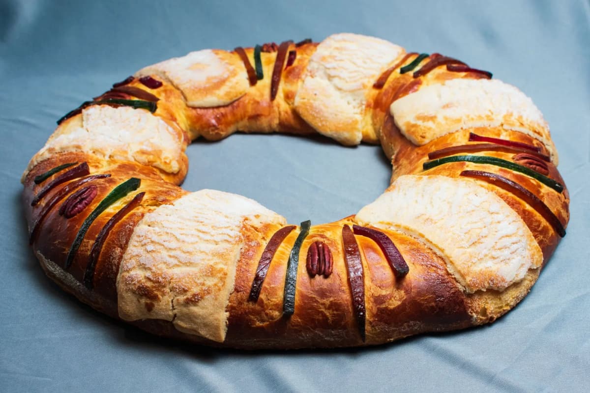 Rosca de Reyes mexicaine, couronne briochée garnie de lanières de fruits confits, de pacanes et de bandes de pâte sucrée